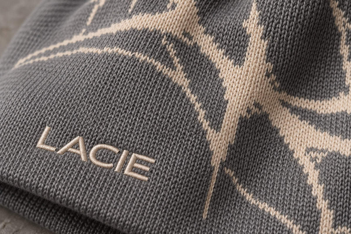 Close-up of the knitted thorn jacquard and cream LACIE embroidery